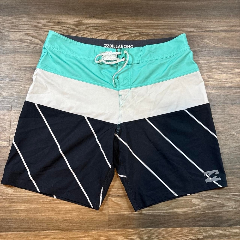 Billabong board shorts with white diagonal stripes on black, teal